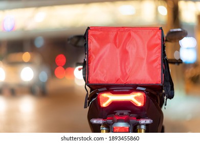 Food Delivery Service ,A Large Red Bag Pace On Motorcycle In The City.