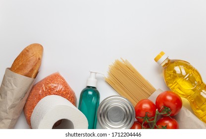 Food delivery service. Buy products online during quarantine. Healthy food and antiseptic on white background. Sunflower oil, tomatos, pasta, bread, lentils, caned food, toilet paper, sanitizer. - Shutterstock ID 1712204446