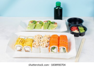 Food Delivery, Takeaway Concept. Lunch Box With Sushi Set. Assorted Sushi, Philadelphia Roll, Cheese, With Squid On White Light Background. Copy Space. Tasty Vegetarian Lunch, Japanese Cuisine Seafood