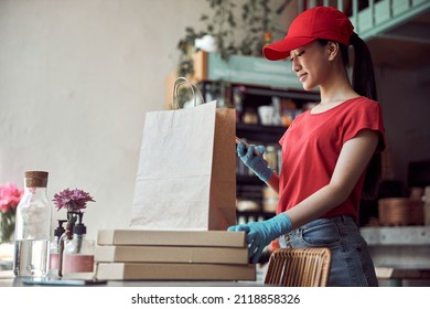 Food Delivery Woman Getting Ready For Work Indoors