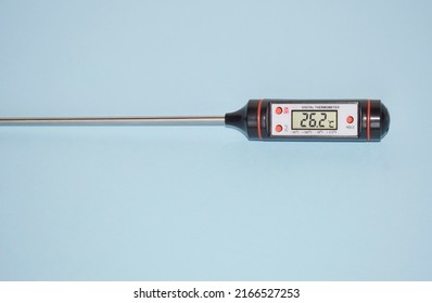 Food digital thermometer with probe and dial on blue background, top view. - Shutterstock ID 2166527253