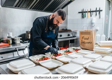 Food in disposable dishes ready for delivery. The chef prepares food in the restaurant and packs it in disposable lunch boxes. - Powered by Shutterstock