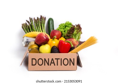 Food Donation Concept. Cardboard Box With Fresh Fruit And Vegetables, Pasta And Canned Food. Vegetarian Grocery Products Isolated On White Background.