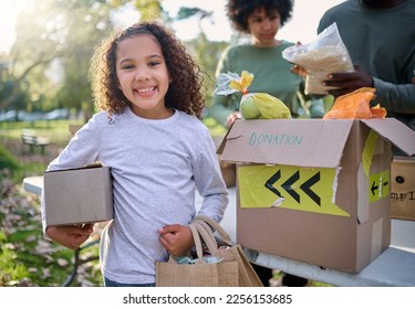 Food, donation and portrait of child in park with smile and grocery box, healthy diet at refugee feeding project. Girl, charity and donations help feed children and support from farm volunteer at ngo - Powered by Shutterstock