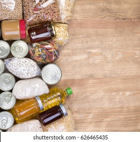 Food donations on wooden background, top view with copy space
