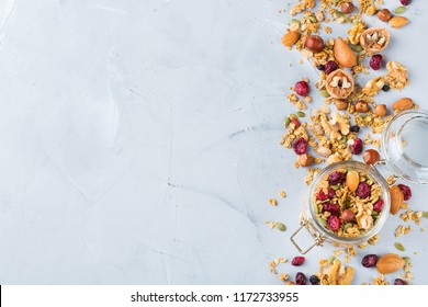 Food and drink, dieting, nutrition breakfast concept. Healthy homemade cereal granola muesli with oats, nuts, dry berries on a cozy kitchen table. Top view flat lay copy space background - Powered by Shutterstock