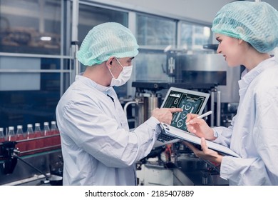 Food and Drink factory worker working together with hygiene monitor control mix ingredients machine with laptop computer - Shutterstock ID 2185407889