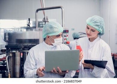 Food And Drink Factory Worker Working Together With Hygiene Monitor Control Mix Ingredients Machine With Laptop Computer