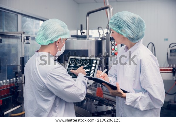 Food
and Drink factory worker working together with hygiene monitor
control mix ingredients machine with laptop
computer