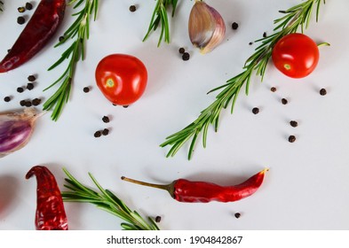 Food and drink healthy lifestyle concept: Italian herbs and spices. Rosemary, tomatoes, garlic and peppers. Top view. Isolated on white. Tomatoes and various herbs spices isolated on white background