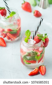 Food And Drink, Holidays Party Concept. Cold Fresh Alcohol Beverage Mojito Cocktail With White Rum, Soda, Red Strawberry And Basil For Refreshment In Summer Days