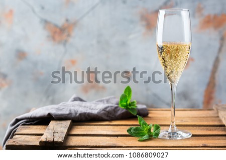 Food and drink, holidays party concept. Cold fresh alcohol beverage champagne sparkling white wine with bubbles in a flute glass on a wooden table. Copy space background Stock foto © 