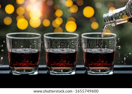 Food and drink, holidays party concept.  Whisky in a glass on the bar, blurred background. Romantic dinner.