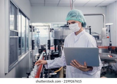 food and drink industry staff worker working at conveyor belt production line machine in beverage factory with clean and hygiene area. - Shutterstock ID 2199267615