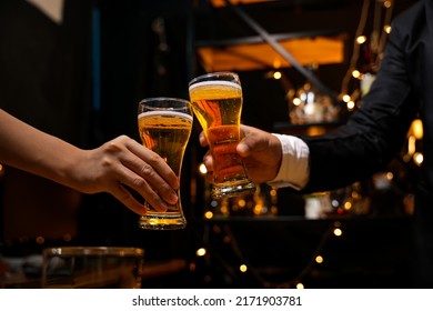 food and drink male friends are happy drinking beer and clinking glasses at a bar or pub. - Powered by Shutterstock