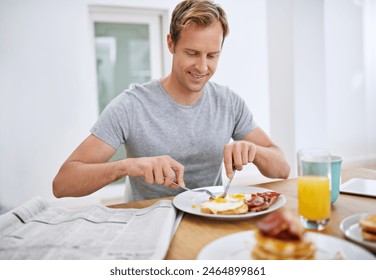 Food, eating breakfast and man with newspaper to relax in morning with smile, balanced diet or wellness. Home, hungry or person at brunch for healthy nutrition with eggs, bread or bacon for protein - Powered by Shutterstock