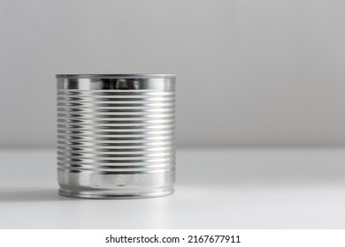 food, eating and preserve concept - close up of tin can with preserve on table