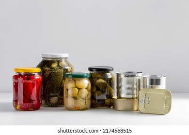 Food, Eating And Preserve Concept - Close Up Of Jars And Tin Cans With Preserved Food On Table