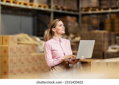 A Food Factory Worker Using Laptop For Checklist In The Storage.