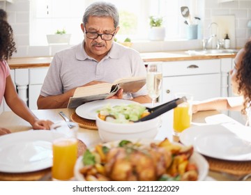 Food, Family And Books With Grandfather Reading To Children At A Table, Bonding And Storytelling Before Sharing A Meal. Bible, Religion And Senior Man Teaching Grandkids Faith And Scripture In Home