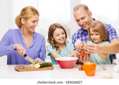 Food, Family, Children, Hapiness And People Concept - Happy Family With Two Kids Making Dinner At Home