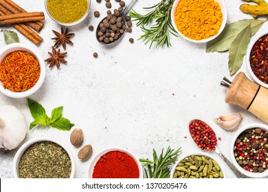 Food frame with spices, herbs and condiments on white stone table. Top View with copy space.
