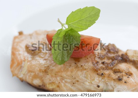 A food is fried salmon fish and vegetable.