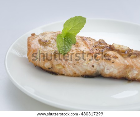 A food is fried salmon fish in white background.