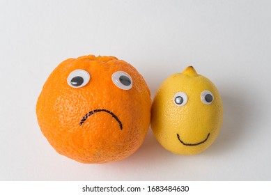 Food with funny face on white background. Sad and cheerful orange lemon with Googly eyes. Pessimist and optimist concept. - Shutterstock ID 1683484630