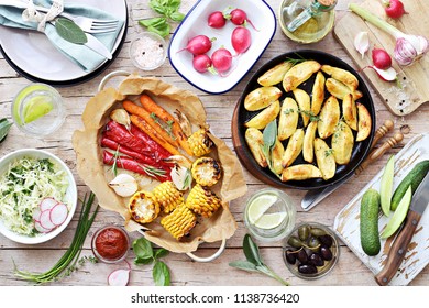 Food Grilled Vegetables Outdoor Table Family Dinner Potato Wedges Roasted Corn Party Picnic. Overhead View, Copy Space