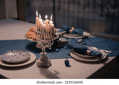 Food For Hanukkah Celebration: Menorah Candles On Wooden Table, Sufganiyot Cake And Table Setting, Jewish Symbol Centerpieces, White And Blue. Holiday Israel Hebrew Traditional Family Celebration