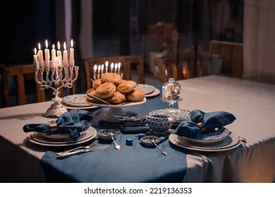 Food For Hanukkah Celebration: Menorah Candles On Wooden Table, Sufganiyot Cake And Table Setting, Jewish Symbol Centerpieces, White And Blue. Holiday Israel Hebrew Traditional Family Celebration