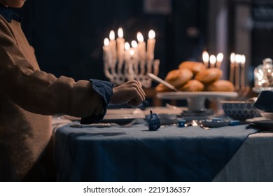 Food For Hanukkah Celebration: Menorah Candles On Wooden Table, Sufganiyot Cake And Table Setting, Jewish Symbol Centerpieces, White And Blue. Holiday Israel Hebrew Traditional Family Celebration