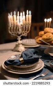 Food For Hanukkah Celebration: Menorah Candles On Wooden Table, Sufganiyot Cake And Table Setting, Jewish Symbol Centerpieces, White And Blue. Holiday Israel Hebrew Traditional Family Celebration