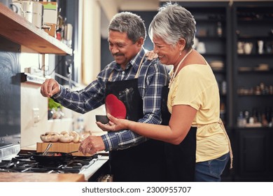 Food, happy senior couple cooking in kitchen and at their home. Collaboration or teamwork of partners, family or marriage and smiling people baking or preparing a meal together in their house - Powered by Shutterstock