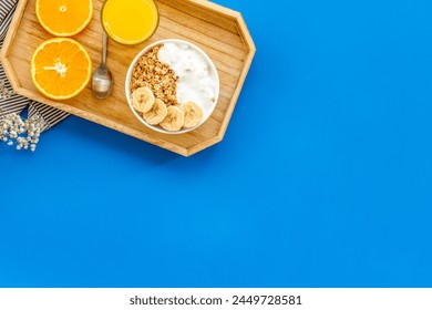 food for healthy breakfast with granola and fresh orange juice on bright blue table background top view mock up - Powered by Shutterstock