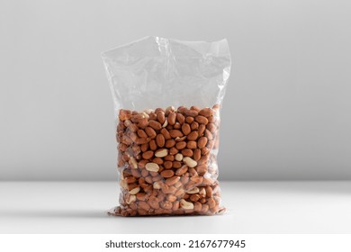 food, healthy eating and diet concept - bag with raw peanuts on white background - Shutterstock ID 2167677945