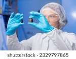 Food industry, candy factory, chemist tests chocolate products from cones in laboratory.