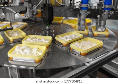 Food Industry And Production Concept - Ice Cream Packaging Automatic Process