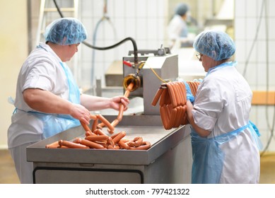 Food Industry: Workers In The Production Of Original German Bratwurst In A Large Butcher's Shop 