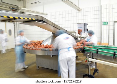 Food Industry Workplace - Butchery Factory For The Production Of Sausages - Women Working On The Assembly Line 