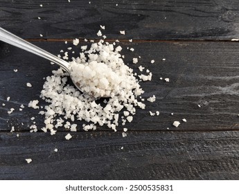 Food ingredient coarse table salt in spoon on the wooden table  - Powered by Shutterstock