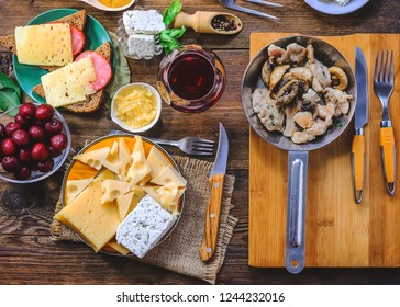 food ingredients for cooking - a glass of wine, fried mushrooms, various cheeses, cottage cheese and spices. cutlery. on a wooden table - Shutterstock ID 1244232016
