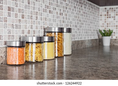 Food Ingredients In Glass Jars On A Kitchen Counter Top.