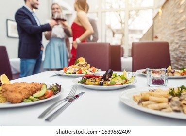 Food in an Italian Restaurant waiting for the guests to be eaten, focus on the dishes - Powered by Shutterstock