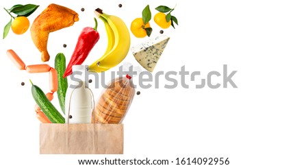 Food items fly out of a paper bag on a white, space for text. Isolated