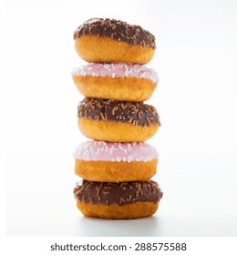 Food, Junk-food And Eating Concept - Close Up Of Glazed Donuts Pile Over White