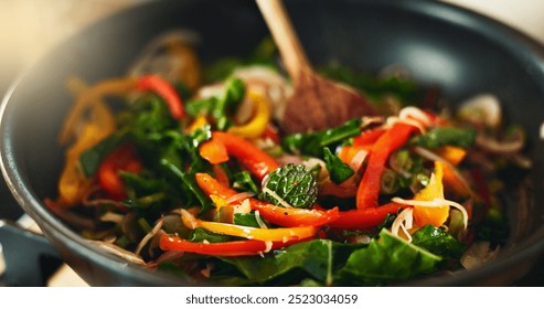 Food, kitchen and spoon in pan for cooking with health, fresh ingredients and wellness with recipe for lunch. Diet, nutrition and vegetable stir fry with stove, heat and meal prep for dinner in home. - Powered by Shutterstock