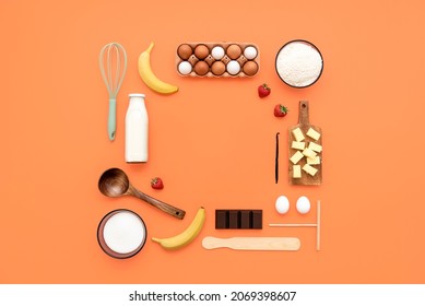 Food knolling on orange background with crepes ingredients and kitchen utensils. Making crepes flat lay, kitchen tools, and ingredients arranged with copy space in the middle. - Shutterstock ID 2069398607