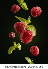 Food levitation. Fresh ripe raspberries flying in the air isolated on black background